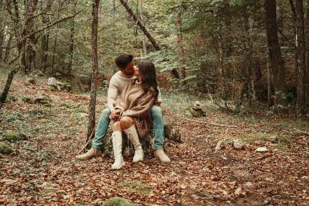 Photo for Young couple sitting in Autumn Leaves - Royalty Free Image