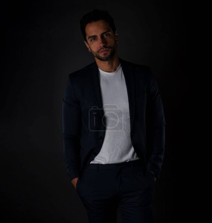 Handsome gentleman donning a sleek navy blue suit. Captured in a studio setting
