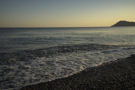 Mediterranean Sea beach with a rocky island in Crete, Greece, Mediterranean Sea