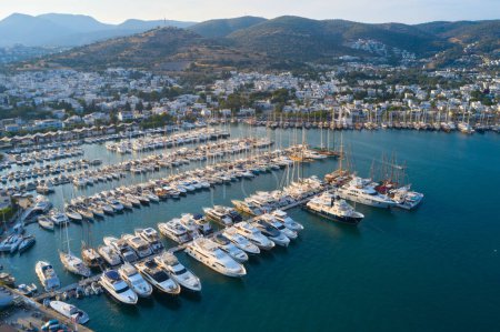 Aerial view of Bodrum city bay with many yachts and boats on a pear. Sea and town landscape of Milta marina in Turkey 