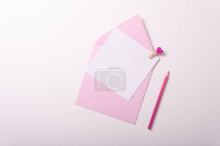 Photo for Valentines day envelope birthday party invitations yellow pink green purple top view white background different size pin - Royalty Free Image