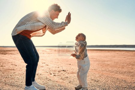 Photo for Father's Day. A young father with his little beloved daughter playing and having fun outside on his weekend. Father traveling with child. - Royalty Free Image