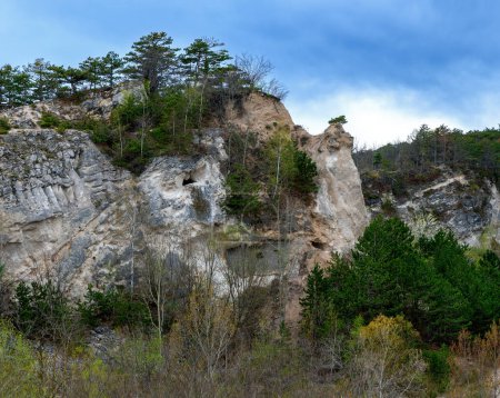 cliff with caves at the former dolomite stone quarry at the Harzberg mountain in Bath Voeslau, Austria