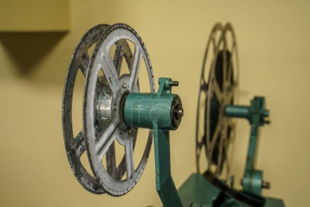 Photo for Unveiling the magic of cinematic nostalgia: The rhythmic hum of a 16mm film projector brings timeless stories to life, one frame at a time - Royalty Free Image