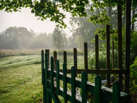 Photo for Old wooden fence in countryside garden with rotten planks - Royalty Free Image