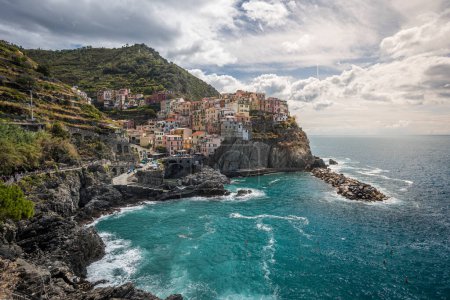 Photo for Stunning view of Manarola village in Cinque Terre National Park, beautiful cityscape with colorful houses and green terraces on cliffs over a sea, Liguria region of Italy. Outdoor travel background - Royalty Free Image