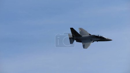 Photo for Ghedi Italy SEPTEMBER, 8, 2022 Military jet trainer aircraft of NATO in flight in a blue sky. Leonardo M-346 Master can emulate the flight characteristics of most common fighter planes. Copy space - Royalty Free Image