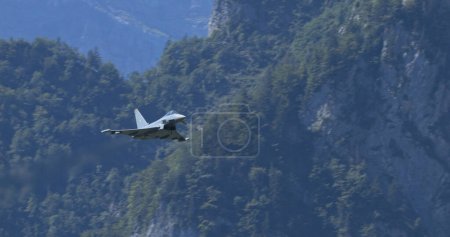 Photo for Mollis, Switzerland, August 19, 2023: Military airplane in tactical flight over a natural landscape, displaying operational readiness and the beauty of flight. Eurofighter Typhoon of German Air Force - Royalty Free Image