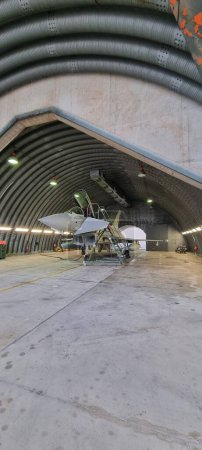Photo for Istrana Italy December 13 2023: Vertical shot of a modern defense aircraft parked in an armored shelter, on alert for immediate takeoff. Perfect for editorial use with ample copy space. - Royalty Free Image