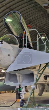 Photo for Istrana Italy December 13 2023: Close-up of the ladder and cockpit of an interceptor military aircraft parked in an armored shelter, ready for NATO defense alert takeoff. Includes copy space. - Royalty Free Image