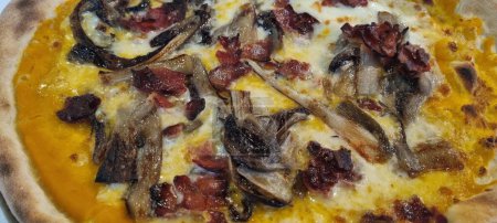 Photo for Close-up of a delicious pizza with mushrooms and bacon, fresh out of the oven - Royalty Free Image