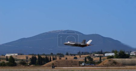 Photo for Athens Greece September 3 2023: US air force f-35 lightning ii jet flying with a mountainous landscape in the background. Space for text. - Royalty Free Image
