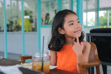 Photo for Little female kid sitting alone and listening to her parent - Royalty Free Image