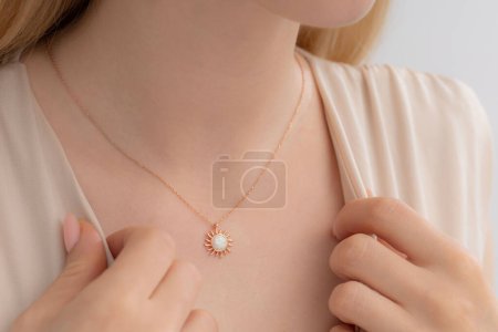Elegant silver necklace around the neck of a well-groomed lady in a cream blouse. Photos for e-commerce, social media, product sales.