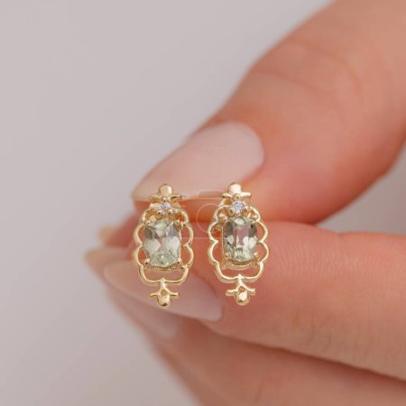 Elegant gold earrings with intricate design on display. Jewelry that attracts attention on women with its vintage appeal.