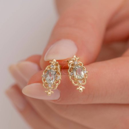 Elegant gold earrings with intricate design on display. Jewelry that attracts attention on women with its vintage appeal.