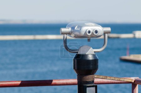 Photo for Binoculars with coin acceptor mounted on the observation deck on the beach. - Royalty Free Image