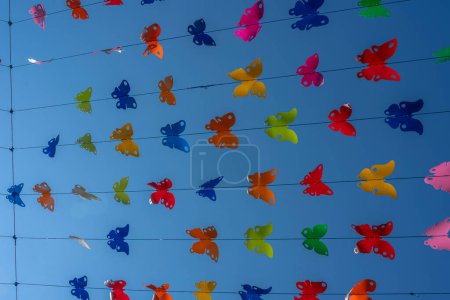 Photo for City of Barr. View of an aerial decoration of colored butterflies with a blue sky background - Royalty Free Image