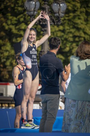 Photo for Paris, France - 08 17 2023: Paris 2024 triathlon test event. French Female athletes winner doing a sign from the heart with his hands - Royalty Free Image