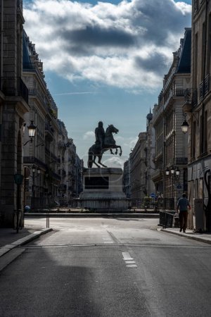 Photo for Paris, France - 08 26 2023: View of the Victories Square and statue of Louis XIV riding a horse in backlight - Royalty Free Image