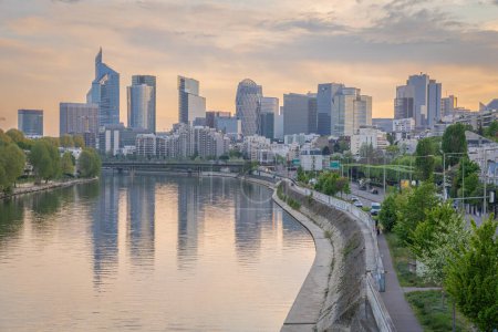 Photo for Levallois, France - 04 16 2020: Panoramic view of the Seine river and La Defense towers district from Levallois Bridge at sunrise - Royalty Free Image