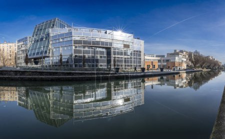 Photo for Paris, France - 01 27 2024: Ourcq Canal. Reflections on the Ourcq canal of a glass building - Royalty Free Image
