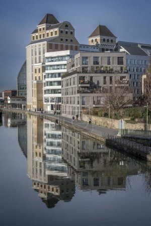 Photo for Paris, France - 01 27 2024: Ourcq Canal. Reflections on the Ourcq canal of Les Grands Moulins of Pantin and buildings around - Royalty Free Image