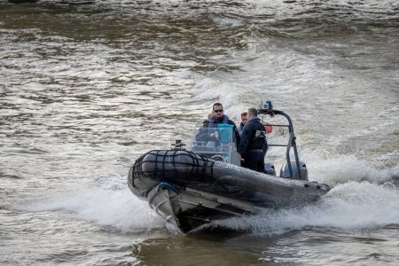 Photo for Paris, France - 02 15 2024: View of water policemen sailing on La Seine with a semi-rigid boat - Royalty Free Image