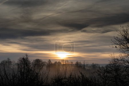 View of a colorful sunrise with mist in the Normandy countryside