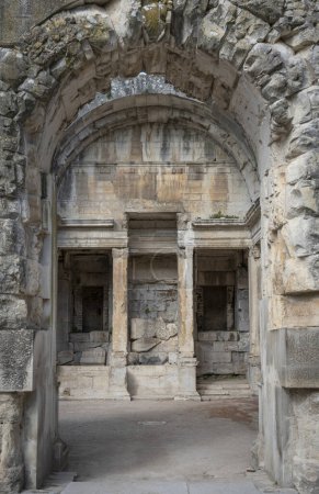 Nimes, Frankreich - 04 17 2024: Die Gärten des Brunnens. Blick auf das Heiligtum des Brunnens mit einer monumentalen hölzernen Installation, die es überquert