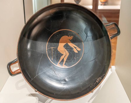 Paris, France - 05 10 2024: Sport in Antiquity. View of a terracotta cup representing an Athlete with Dumbbells, long jump