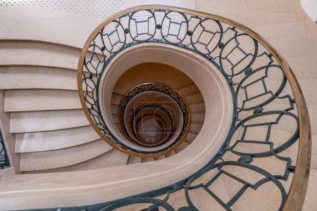 Paris, France - 05 10 2024: Bibliotheque Nationale de France Richelieu. View of a circular marble staircase from above