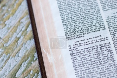 Photo for Jesus Christ heals on the Sabbath verses in open holy bible book. Christian biblical concept of obedience, salvation, compassion, help, and love of God. - Royalty Free Image