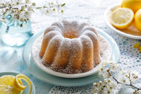 Photo for Lemon bundt cake (Babka) sprinkled with powdered sugar, close up view - Royalty Free Image