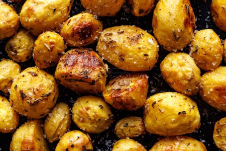 Close up of roasted potatoes seasoned with a mixture of aromaticsherbs and spices with olive oil
