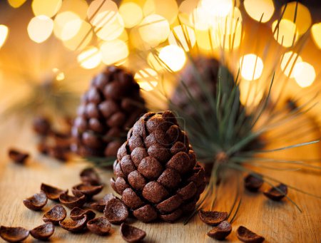 Photo for Chocolate pine cones made with chocolate cereal, focus on the pine cone in the center. Christmas delicious dessert - Royalty Free Image