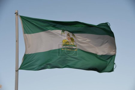Photo for Andalusian flag blowing in the wind with a blue sky in the background - Royalty Free Image