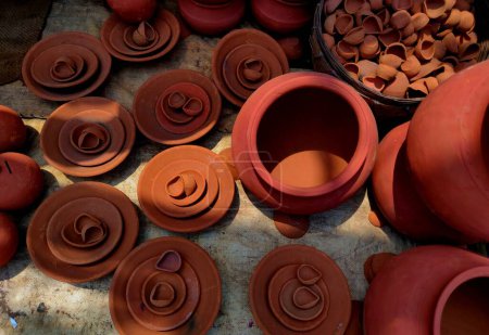 Clay Diyas, Plates, and Pottery Showcase Clay Pottery and Diya Art for sale on a road side vendor