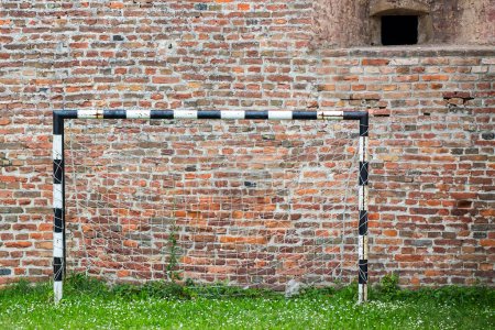 Photo for Soccer Goal, Football goal for football with grass and a wall of bricks - Royalty Free Image