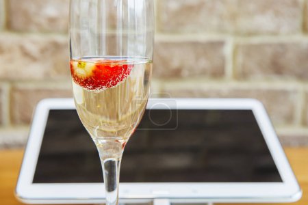 Photo for Tablet pc with champagne glass - Royalty Free Image