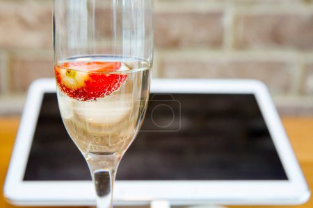 Photo for Tablet pc with champagne glass - Royalty Free Image