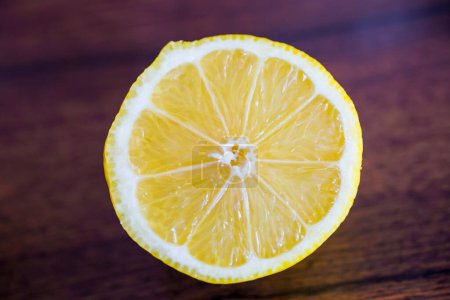 Photo for Lemon slice on wooden table - Royalty Free Image