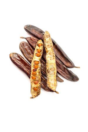Photo for Group of dried carob pods whole with seeds, isolated on white background - Royalty Free Image