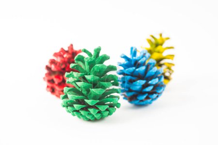 Photo for Yellow, green, blue and red set of pine cones isolated on white background - Royalty Free Image