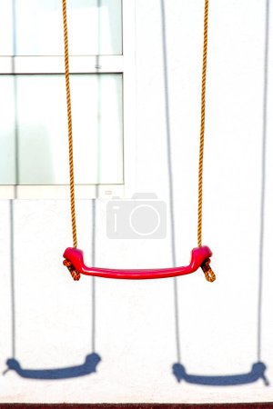 Photo for Set of red swings on modern kids playground - Royalty Free Image