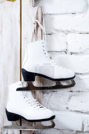 Photo for Skates hanging on a wooden door - Royalty Free Image