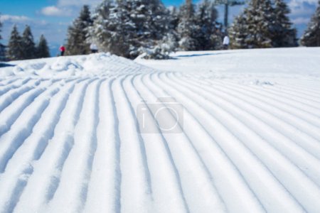 Photo for Snow lines made from a snow machine on a ski slope - Royalty Free Image