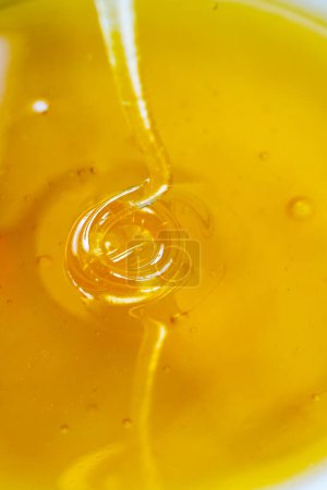 Photo for Yellow honey flowing for background - Royalty Free Image
