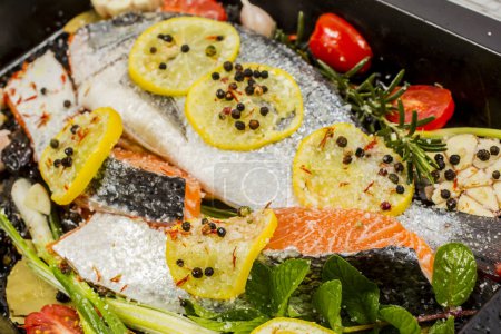Photo for Fresh sea bream and salmon on dark  background. Fish with aromatic herbs, spices and vegetables - healthy food, diet or cooking concep - Royalty Free Image