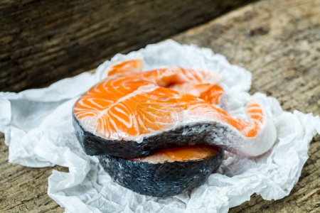 Photo for Raw salmon fish steak on wooden rustic background - Royalty Free Image